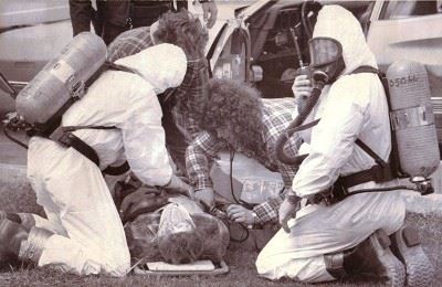 Hazmat Clad Firefighters With Person on Stretcher